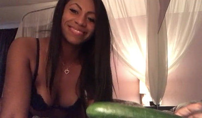 Stunning black chick greases up a pickle and puts it inside her tight wet puss