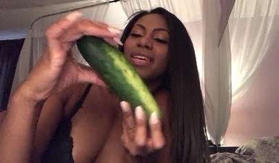 Stunning black chick greases up a pickle and puts it inside her tight wet puss