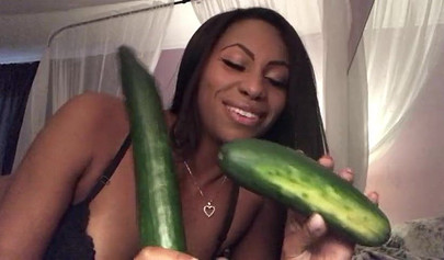 Stunning black chick greases up a pickle and puts it inside her tight wet puss