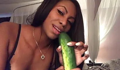 Stunning black chick greases up a pickle and puts it inside her tight wet puss