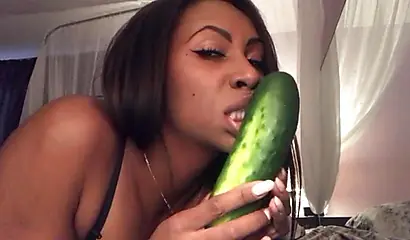 Stunning black chick greases up a pickle and puts it inside her tight wet puss