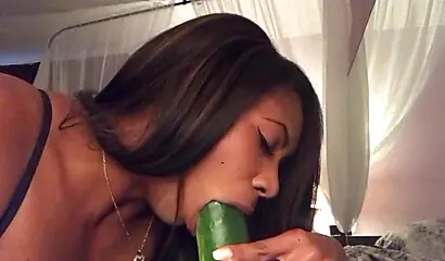Stunning black chick greases up a pickle and puts it inside her tight wet puss