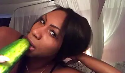 Stunning black chick greases up a pickle and puts it inside her tight wet puss