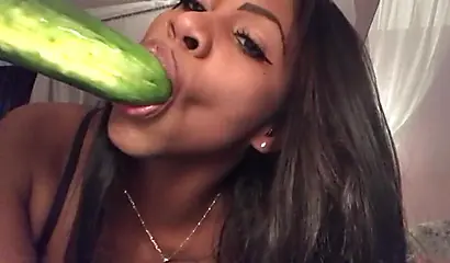 Stunning black chick greases up a pickle and puts it inside her tight wet puss