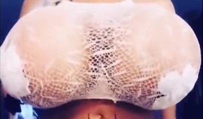 Black chick with implants shows her massive titties and loves the feeling of it