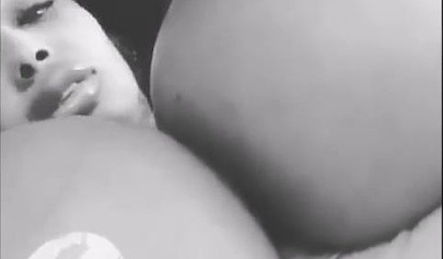 Black chick with implants shows her massive titties and loves the feeling of it