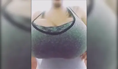 Black chick with implants shows her massive titties and loves the feeling of it