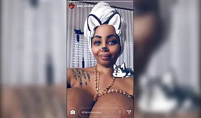 Black chick with implants shows her massive titties and loves the feeling of it