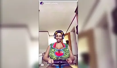 Black chick with implants shows her massive titties and loves the feeling of it