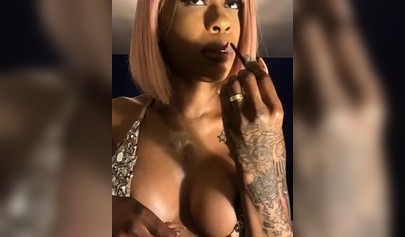 Dashing ebony Instagram model with pink hair teases with her perfect tattooed body