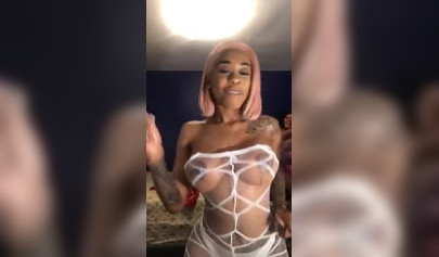 Dashing ebony Instagram model with pink hair teases with her perfect tattooed body