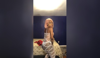 Dashing ebony Instagram model with pink hair teases with her perfect tattooed body