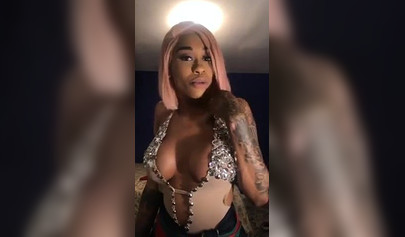Dashing ebony Instagram model with pink hair teases with her perfect tattooed body