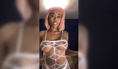 Dashing ebony Instagram model with pink hair teases with her perfect tattooed body