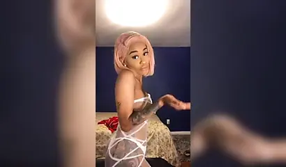 Dashing ebony Instagram model with pink hair teases with her perfect tattooed body