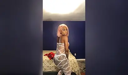 Dashing ebony Instagram model with pink hair teases with her perfect tattooed body