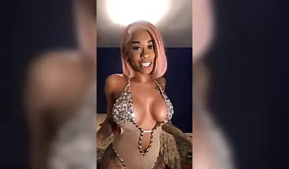 Dashing ebony Instagram model with pink hair teases with her perfect tattooed body