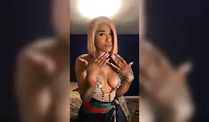 Dashing ebony Instagram model with pink hair teases with her perfect tattooed body