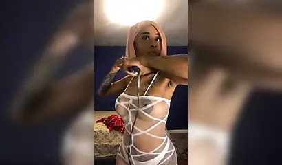 Dashing ebony Instagram model with pink hair teases with her perfect tattooed body
