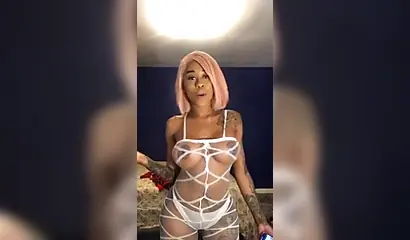 Dashing ebony Instagram model with pink hair teases with her perfect tattooed body