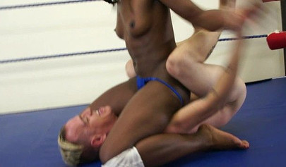 Athletic black babe subdues a white man through wrestling and jerks his cock off