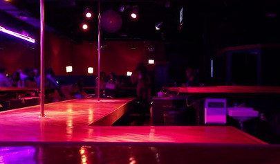 Ebony chick with massive tits and a huge belly dances in an empty strip club