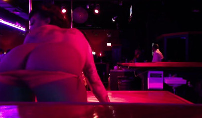 Ebony chick with massive tits and a huge belly dances in an empty strip club