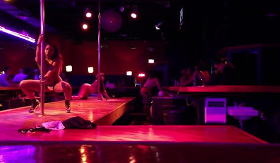 Ebony chick with massive tits and a huge belly dances in an empty strip club