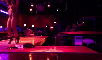 Ebony chick with massive tits and a huge belly dances in an empty strip club