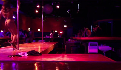 Ebony chick with massive tits and a huge belly dances in an empty strip club