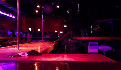 Ebony chick with massive tits and a huge belly dances in an empty strip club