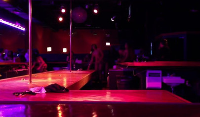 Ebony chick with massive tits and a huge belly dances in an empty strip club