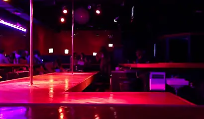 Ebony chick with massive tits and a huge belly dances in an empty strip club