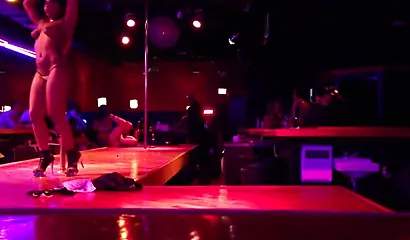 Ebony chick with massive tits and a huge belly dances in an empty strip club
