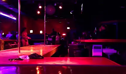 Ebony chick with massive tits and a huge belly dances in an empty strip club