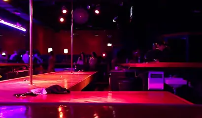 Ebony chick with massive tits and a huge belly dances in an empty strip club