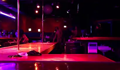 Ebony chick with massive tits and a huge belly dances in an empty strip club