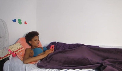 Skinny ebony chick with curly hair pleases herself with her fingers and a dildo