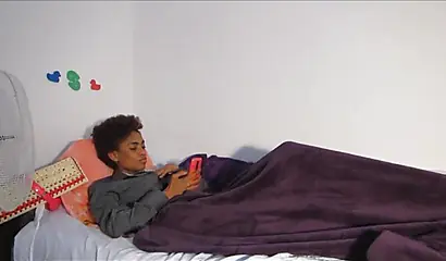 Skinny ebony chick with curly hair pleases herself with her fingers and a dildo