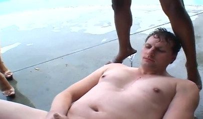 Three horny ghetto black chicks dominate a white guy and fuck him with strapons