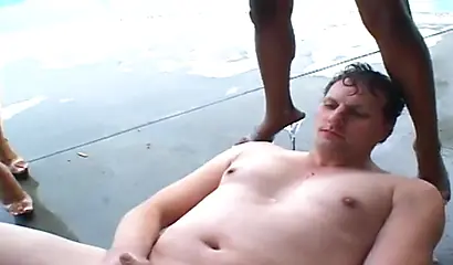 Three horny ghetto black chicks dominate a white guy and fuck him with strapons