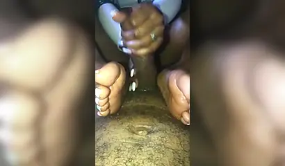 Kinky ebony chick gives a long and wet blowjob and footjob to a big black cock
