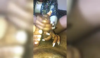 Kinky ebony chick gives a long and wet blowjob and footjob to a big black cock