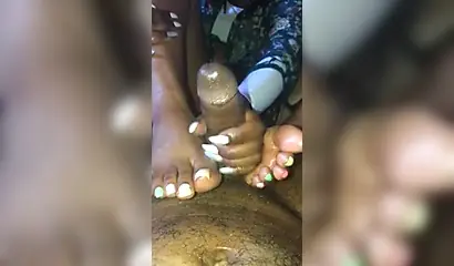 Kinky ebony chick gives a long and wet blowjob and footjob to a big black cock