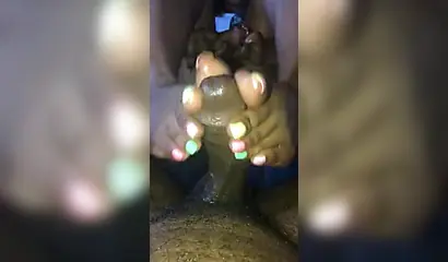 Kinky ebony chick gives a long and wet blowjob and footjob to a big black cock