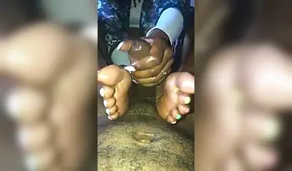 Kinky ebony chick gives a long and wet blowjob and footjob to a big black cock