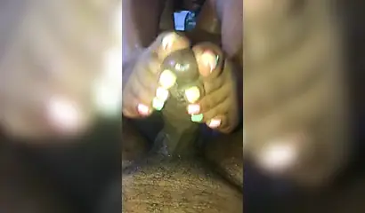 Kinky ebony chick gives a long and wet blowjob and footjob to a big black cock