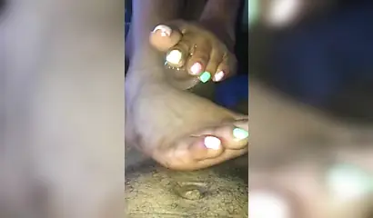 Kinky ebony chick gives a long and wet blowjob and footjob to a big black cock