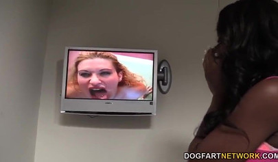 Gorgeous black chick Jezabel Vessir slobbers on a big white dick in a glory hole