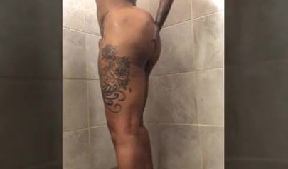 Horny mature ebony with short blonde hair masturbates vigorously while in a shower